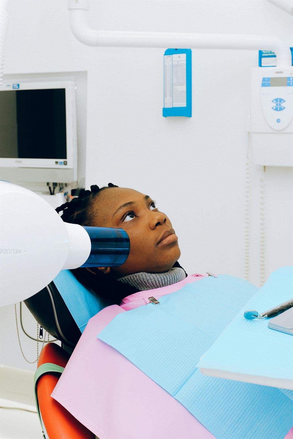 African patient receiving a dental scan and oral examination